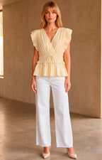Blusa peplum plisada con volantes