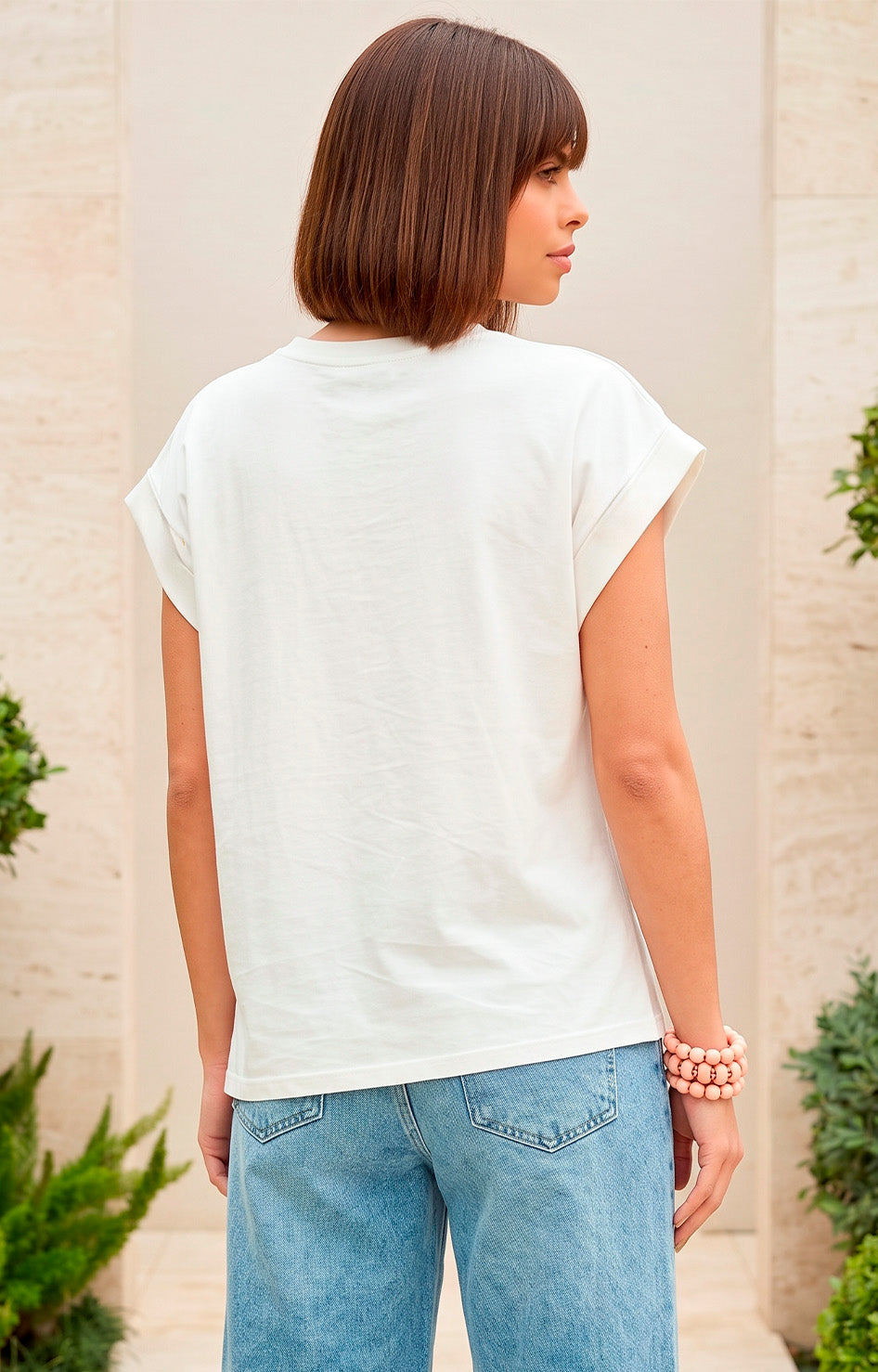 Blusa asimétrica con aplicaciones doradas