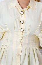 Blusa camisera amarilla tipo peplum