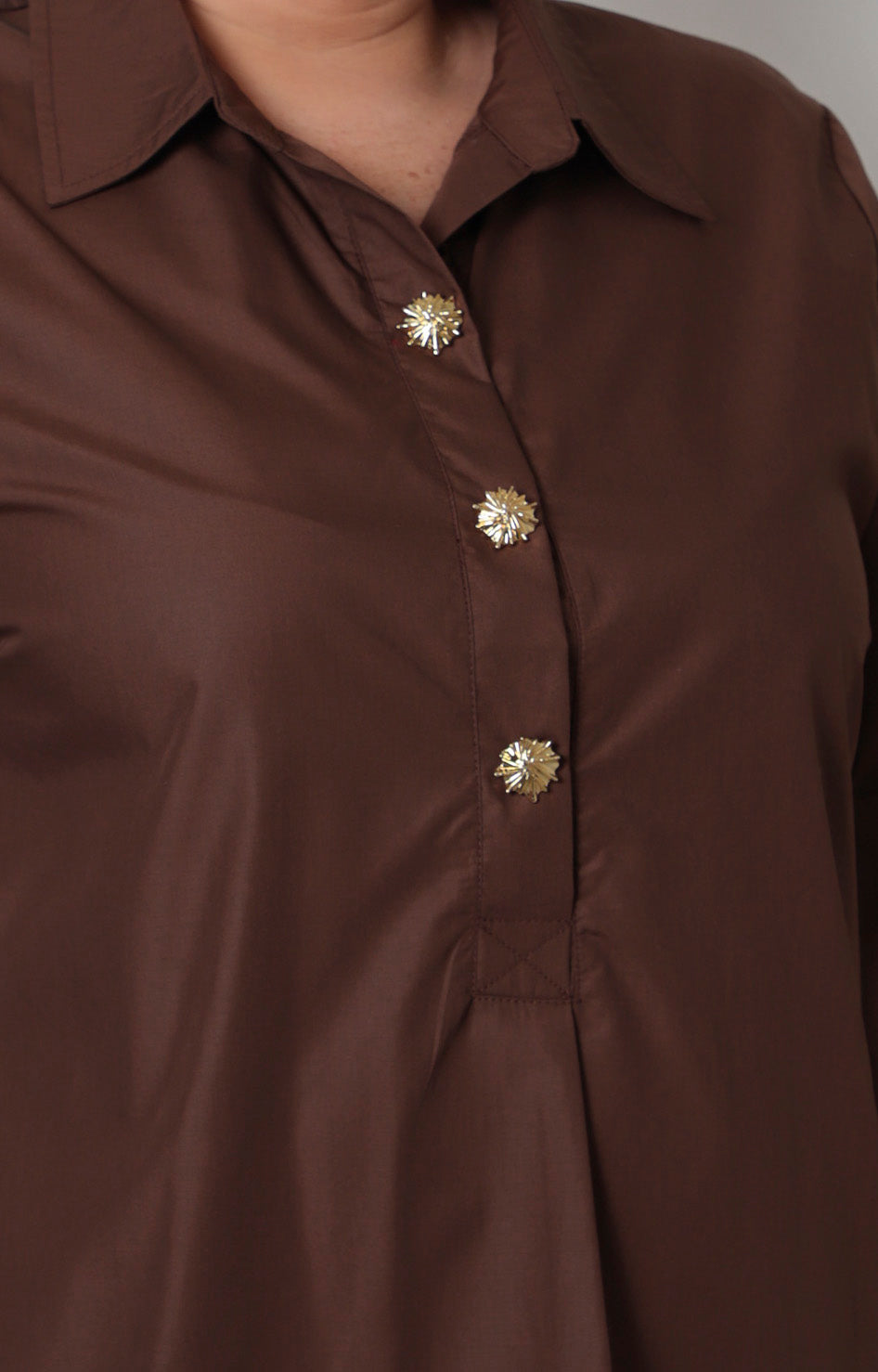 Blusa camisera curvy de Boutiquemirel con botones dorados, manga larga y diseño elegante en color neutro.