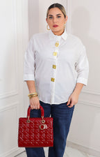 Blusa lisa con botones asimétricos